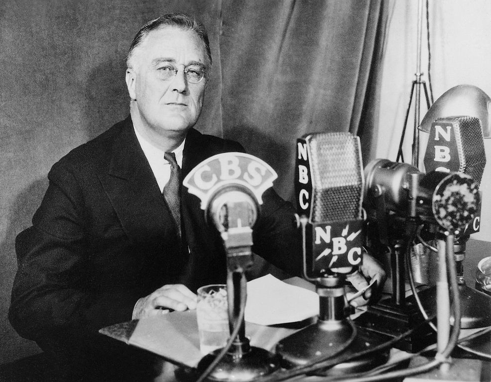 Franklin Roosevelt - Integrated CRM US President Franklin Roosevelt sitting in front of a number of microhpnes