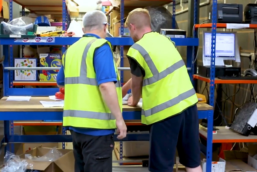 no-lazyload Warehouse staff planning out job allocations.